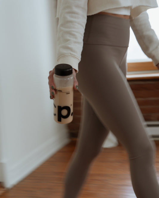 COLDPOW bottle with protein shake. Woman holding eco-friendly hydration bottle, lifestyle brand.